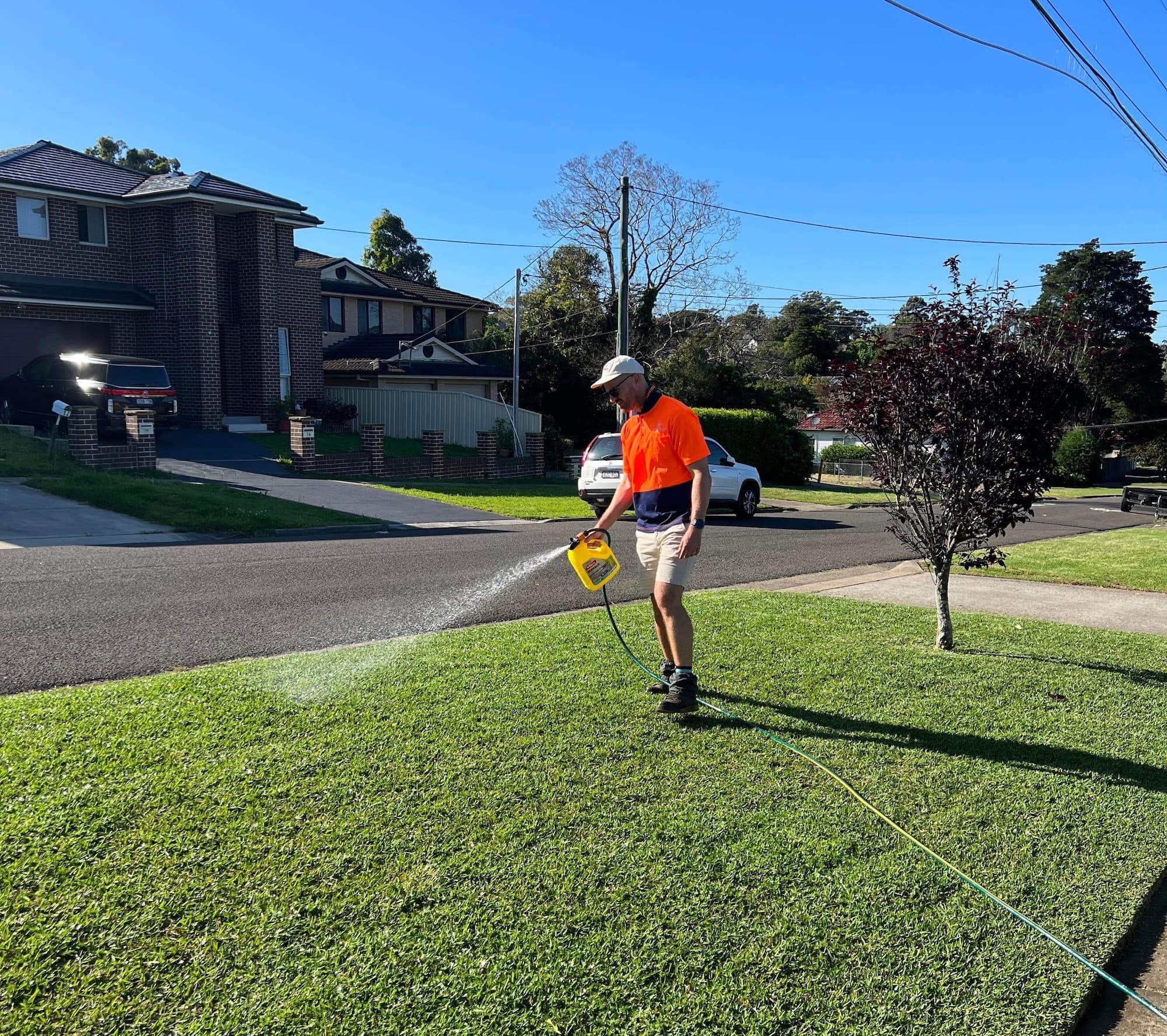 Gardening Sydney crew member treating a lawn